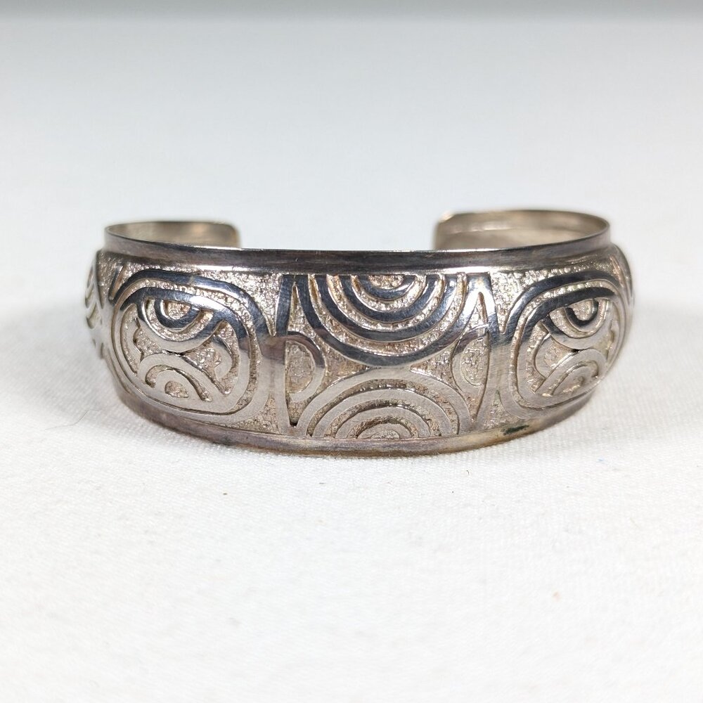 Silver toned cuff bracelet with abstract pattern